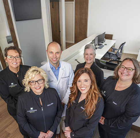 Overhead shot of a dental team in Jeffersonville discussing patient charts