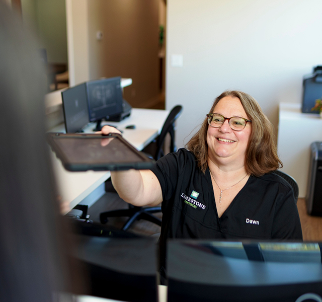 Dental team member accepting patient's dental insurance forms